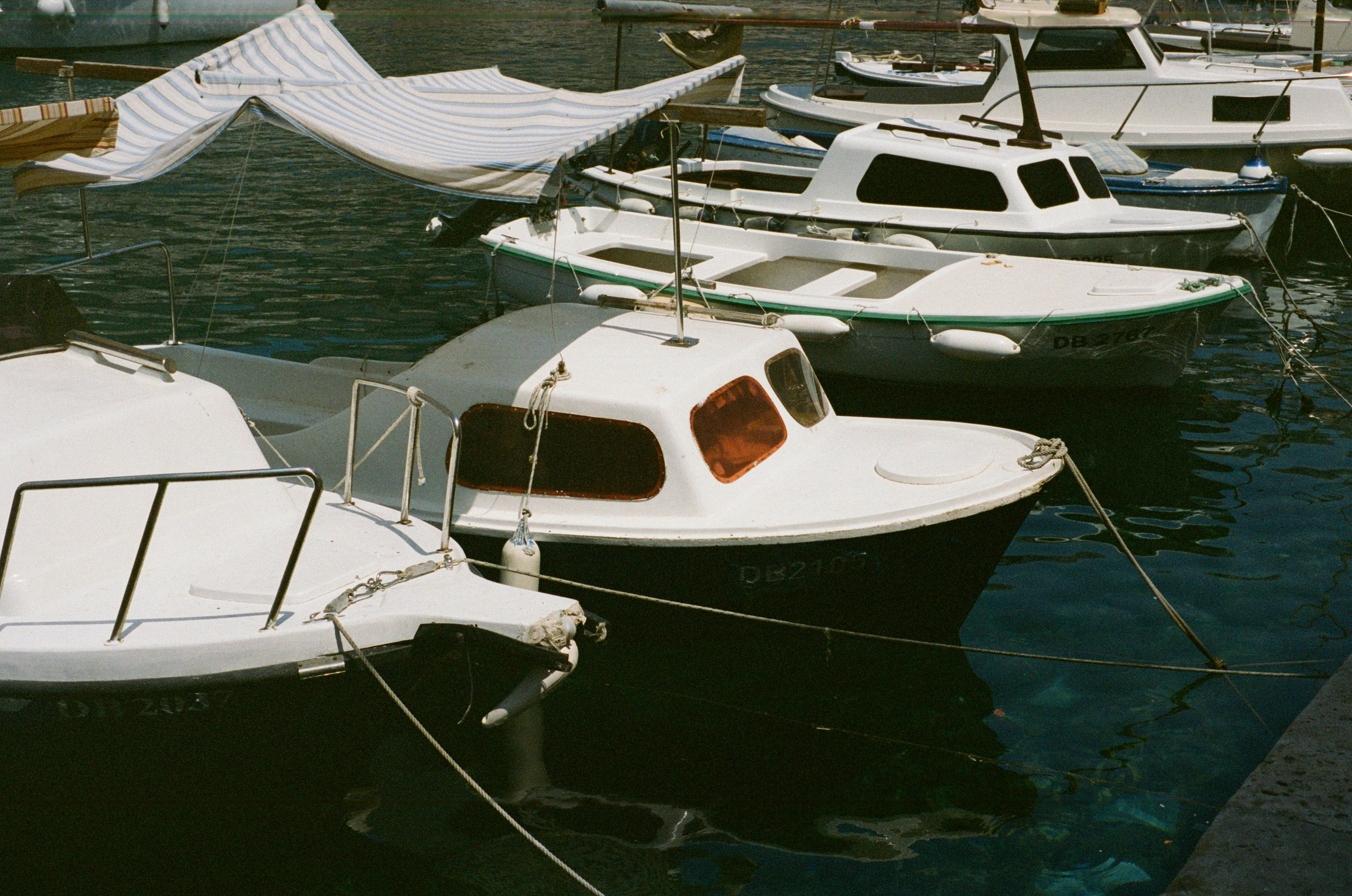 Reusable shopping bags and a handwritten list for yacht provisioning laid out before a supermarket run near a UK marina