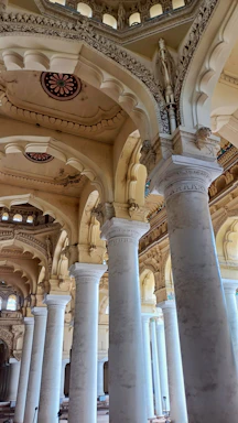 A large room with columns and a clock on the wall