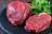 Two steaks on a plate with parsley