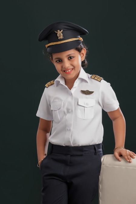 A little girl dressed in a pilot's uniform