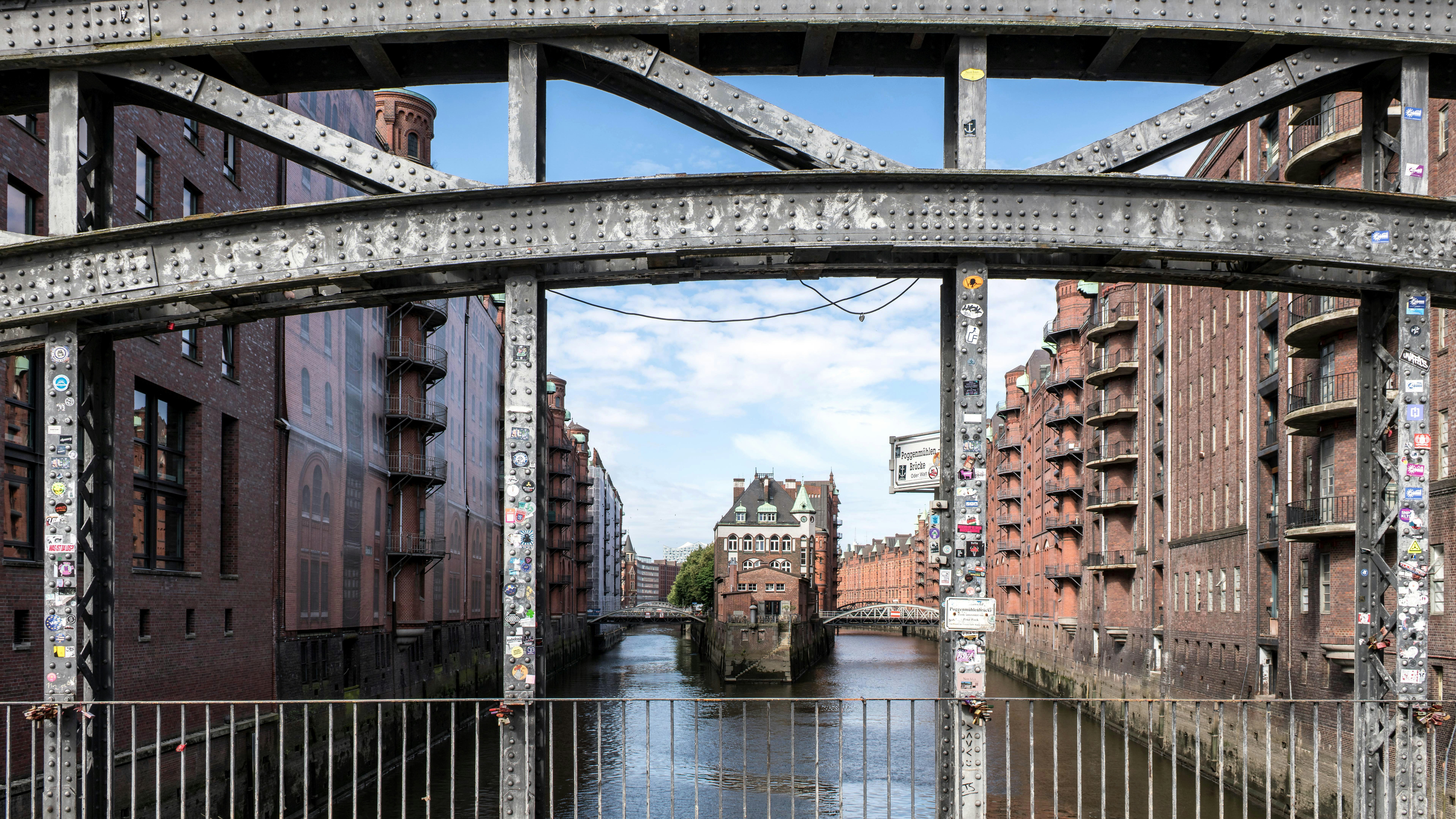 A bridge over a body of water with buildings in the background