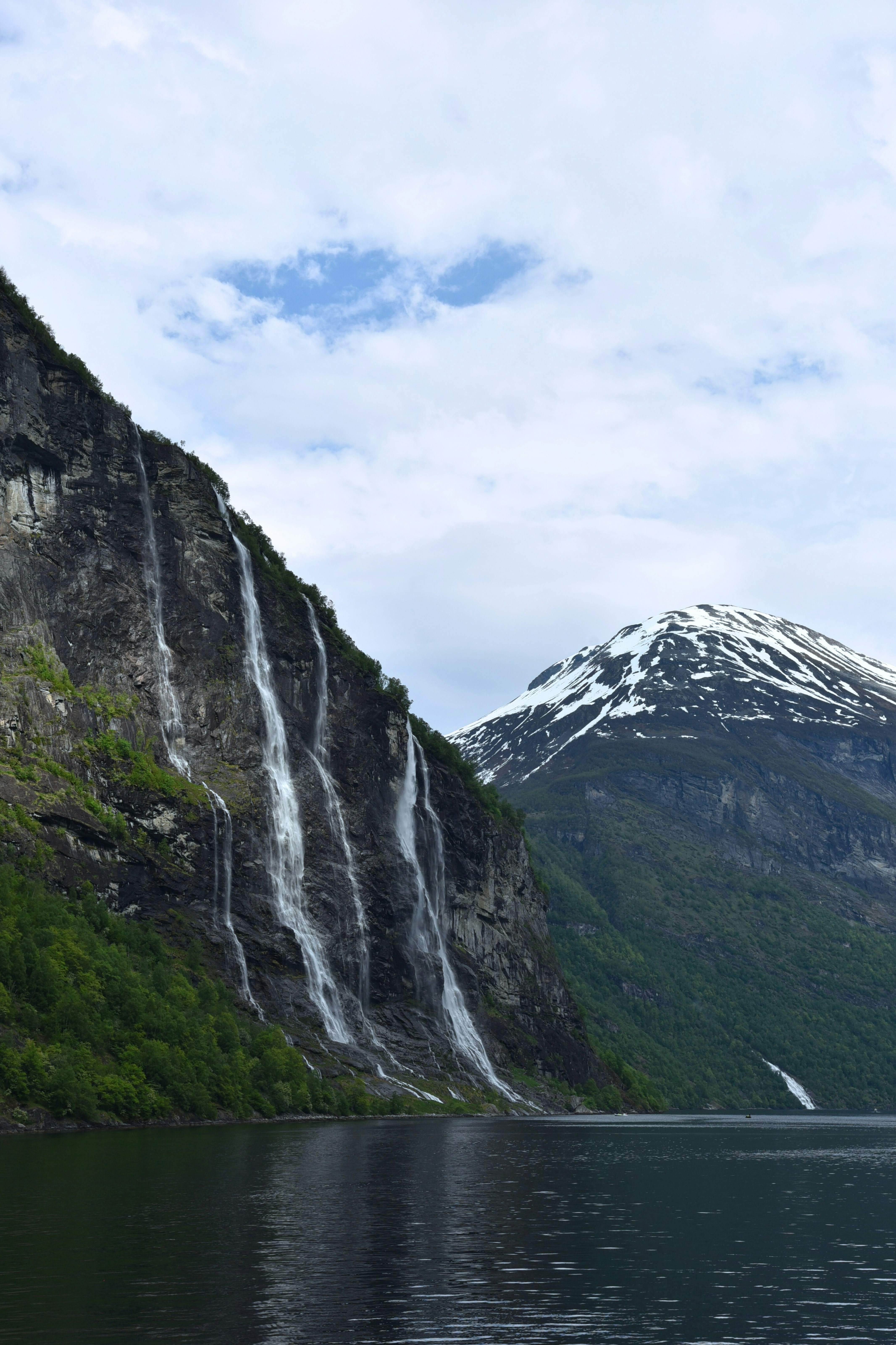 A mountain with a waterfall in the middle of it