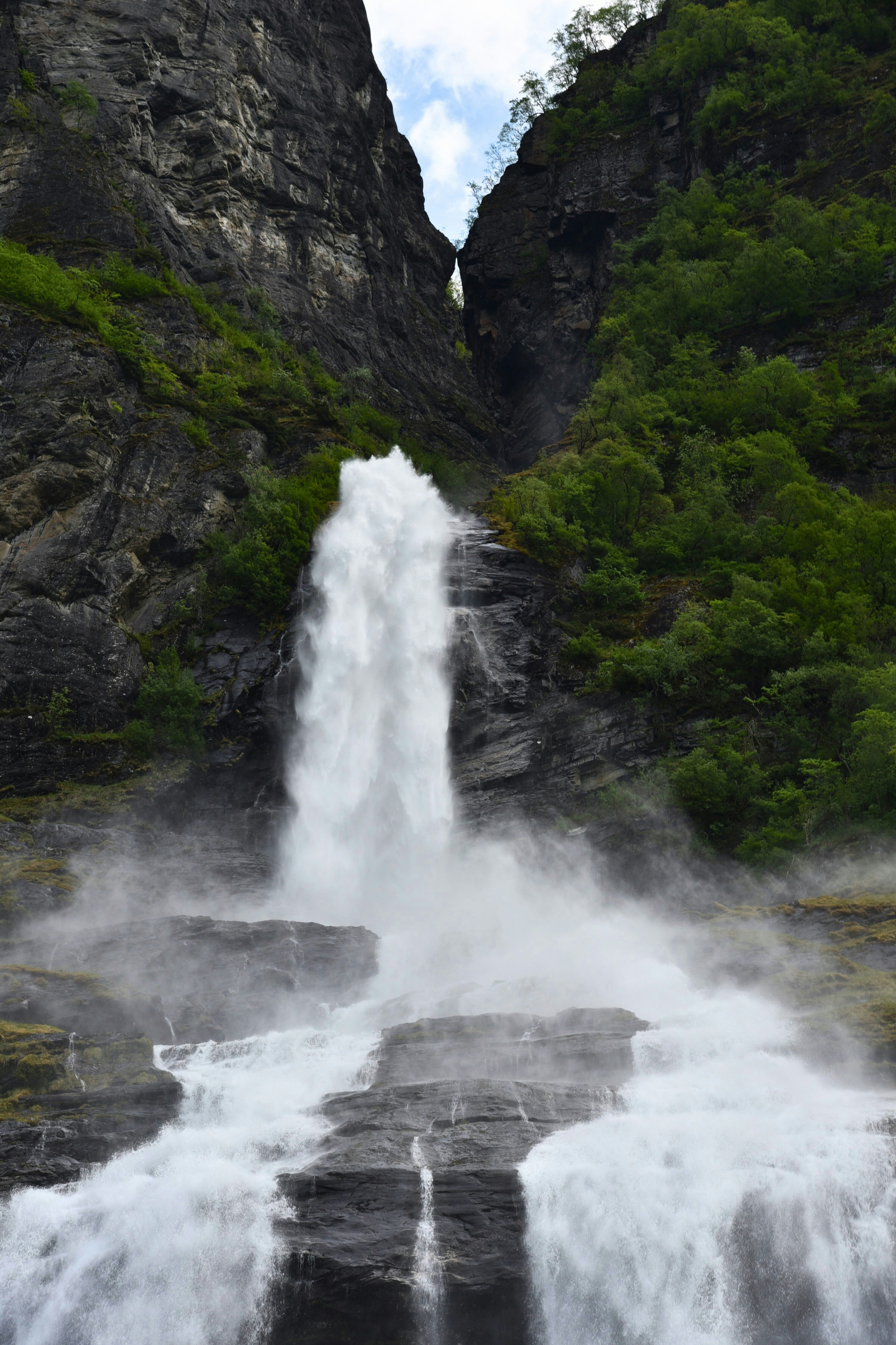 A large waterfall with water coming out of it