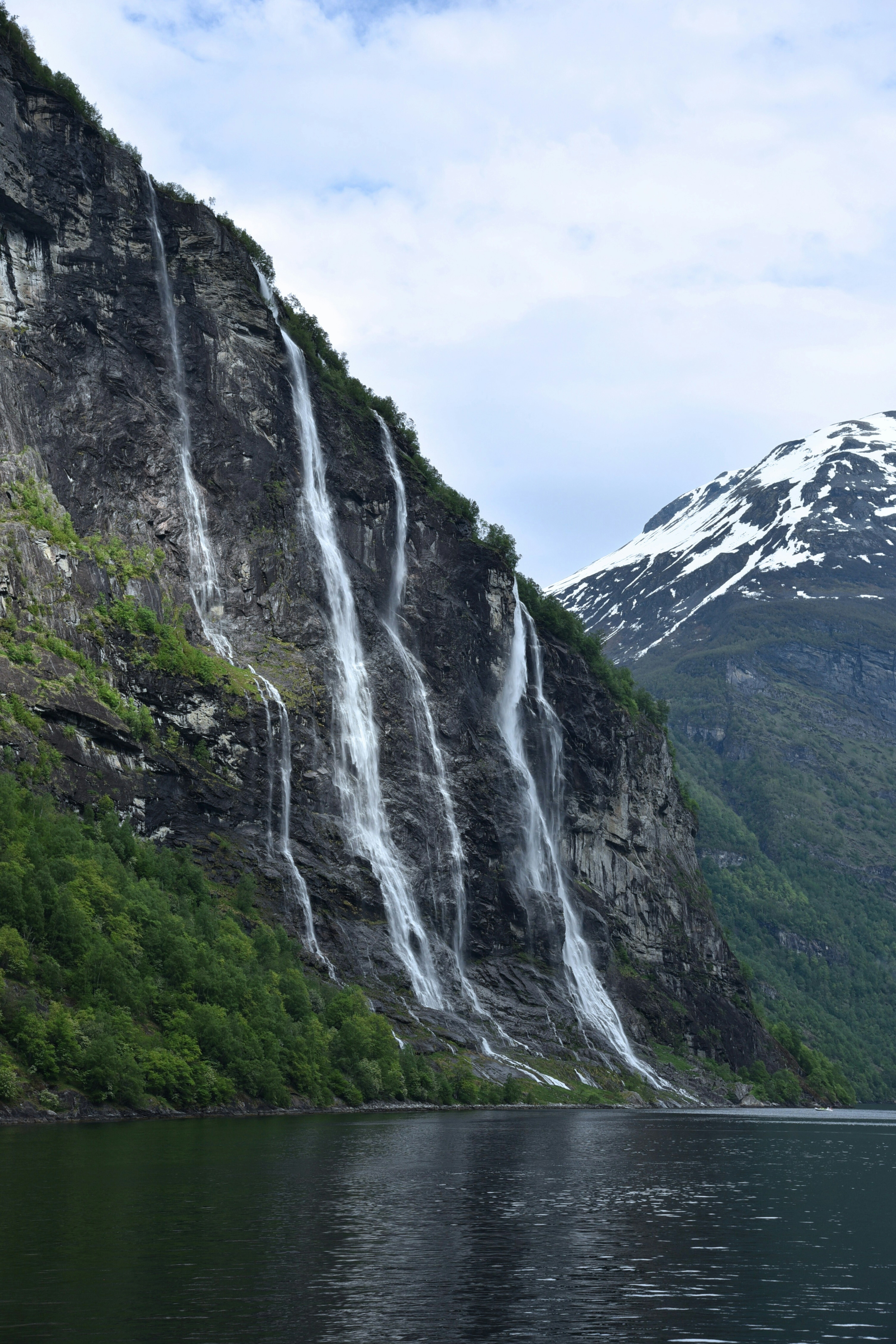 A large waterfall cascading into the side of a mountain