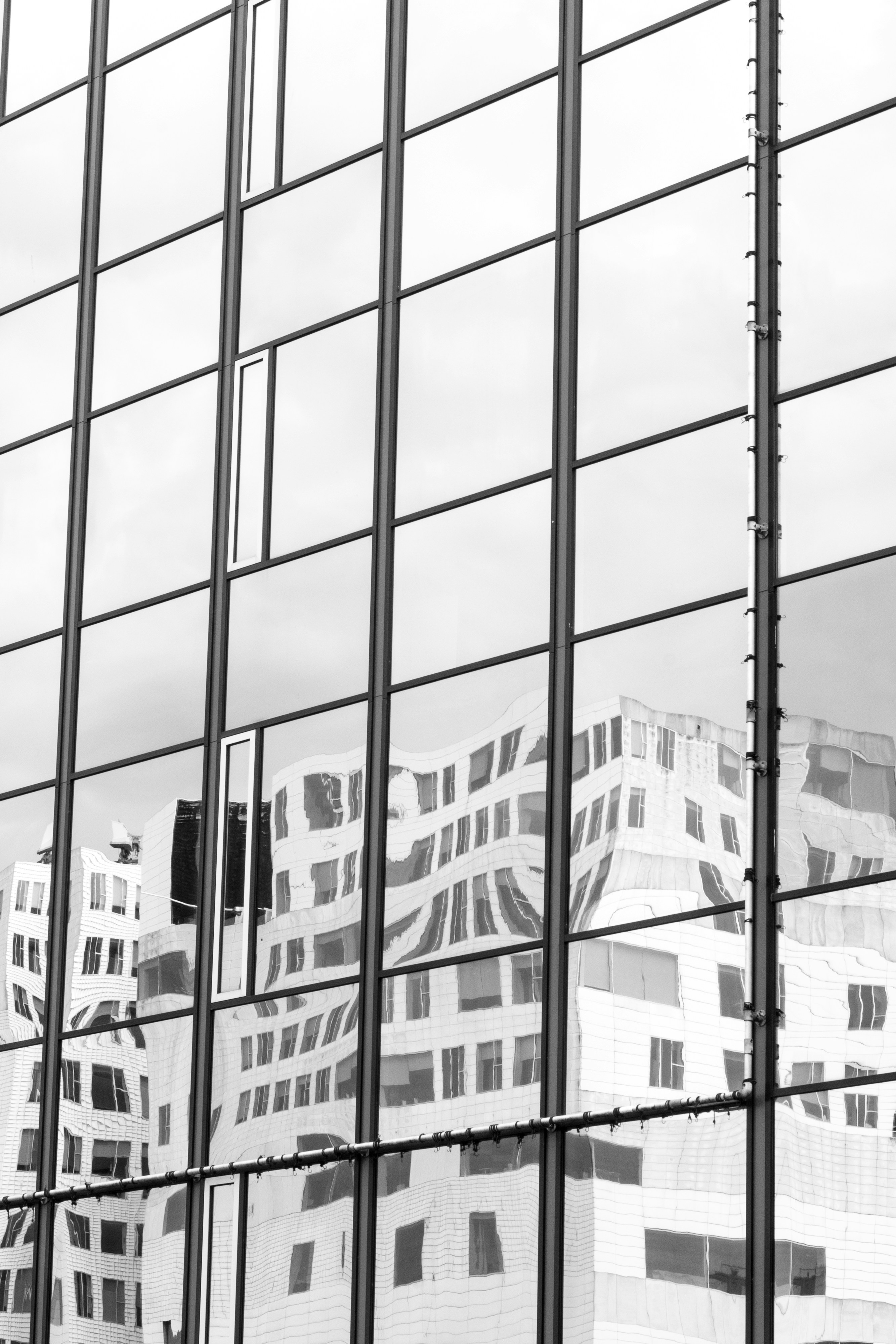 The reflection of a building in the windows of another building