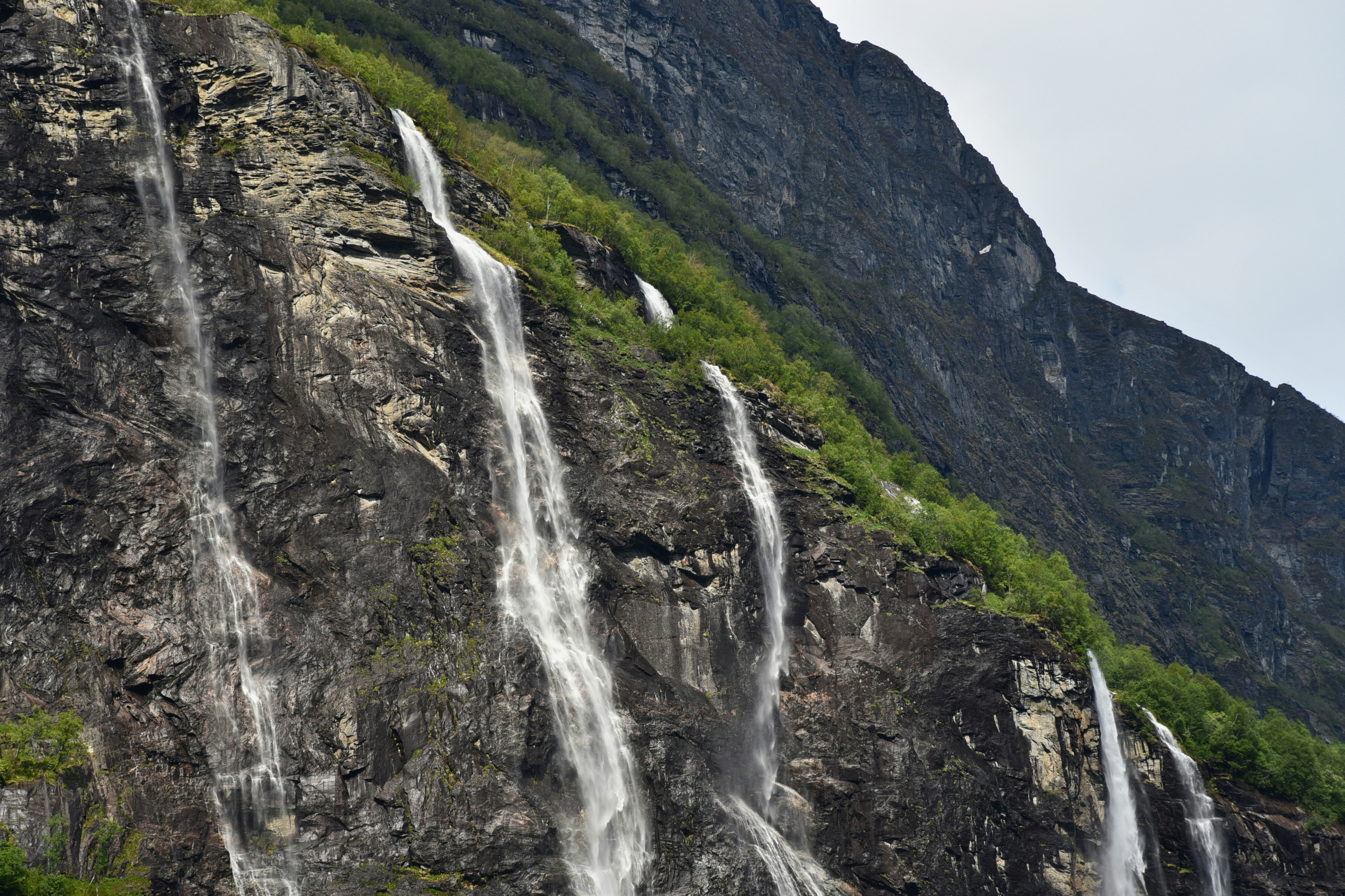 A group of people standing in front of a waterfall