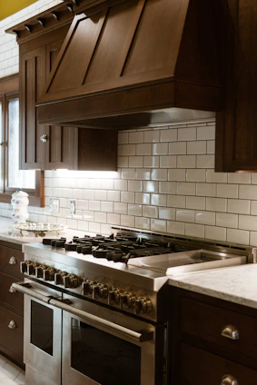 A kitchen with a stove, oven, and cabinets
