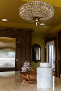 A chandelier hanging from a ceiling in a kitchen