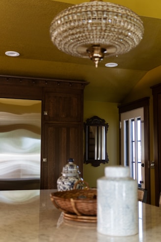 A chandelier hanging from a ceiling in a kitchen