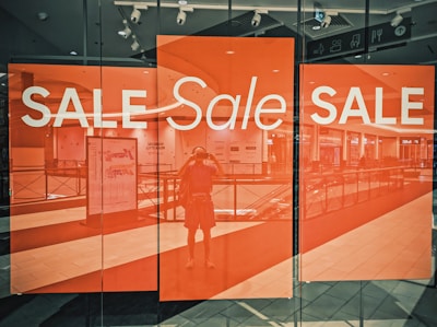 A store window with a sale sign on it