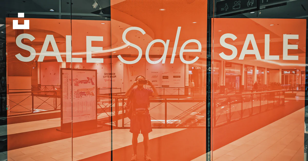A store window with a sale sign on it photo – Free Building Image on ...