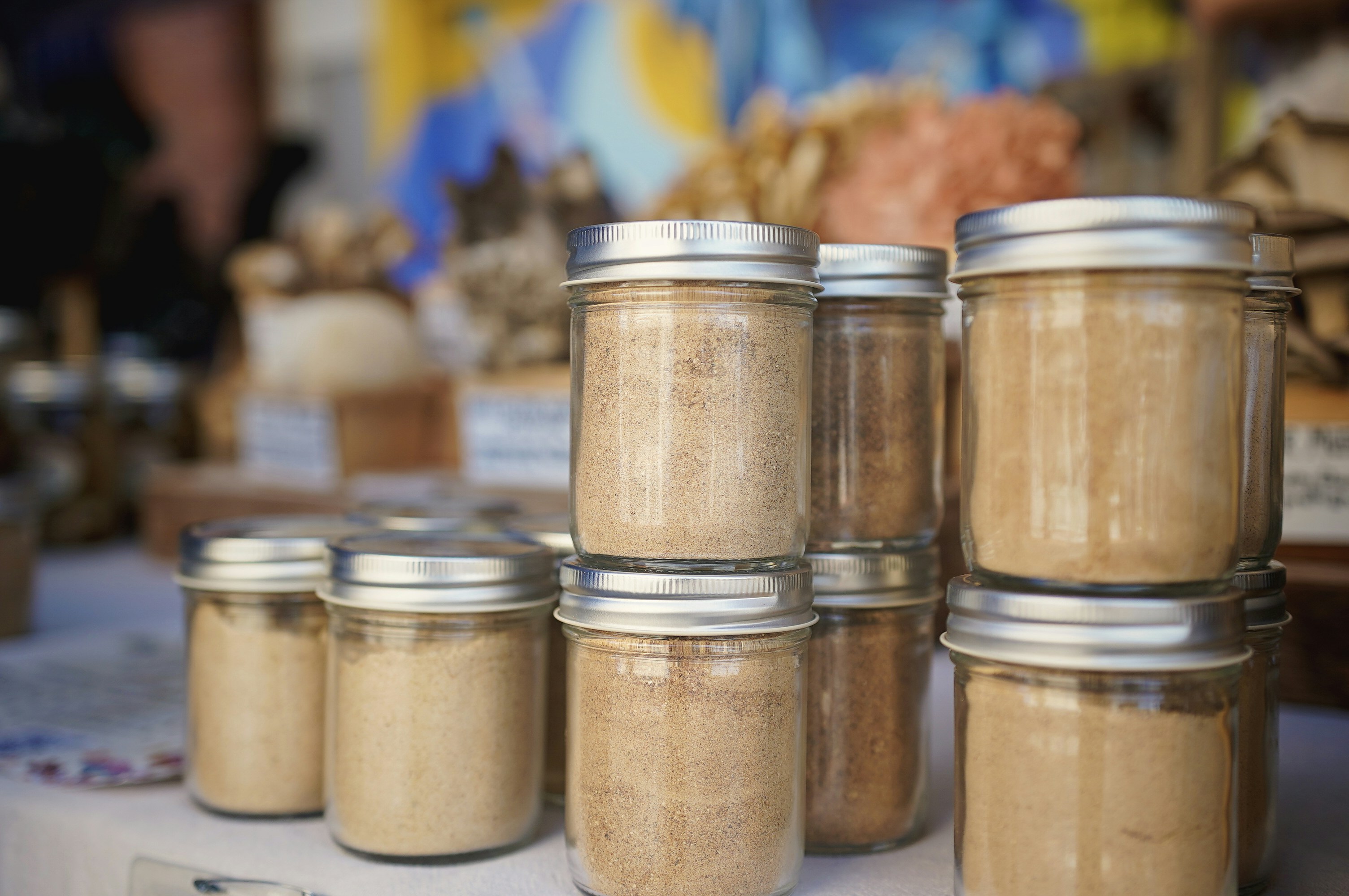 A table topped with lots of jars filled with food