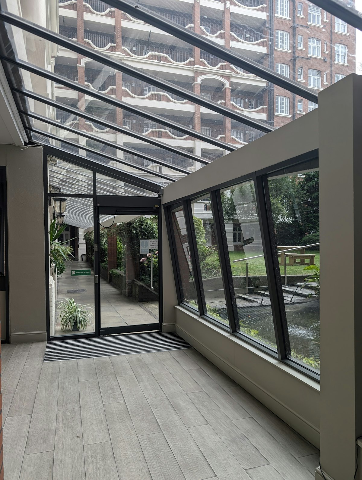 Interior of a rear extension with a glass roof and timber floor admitting natural daylight