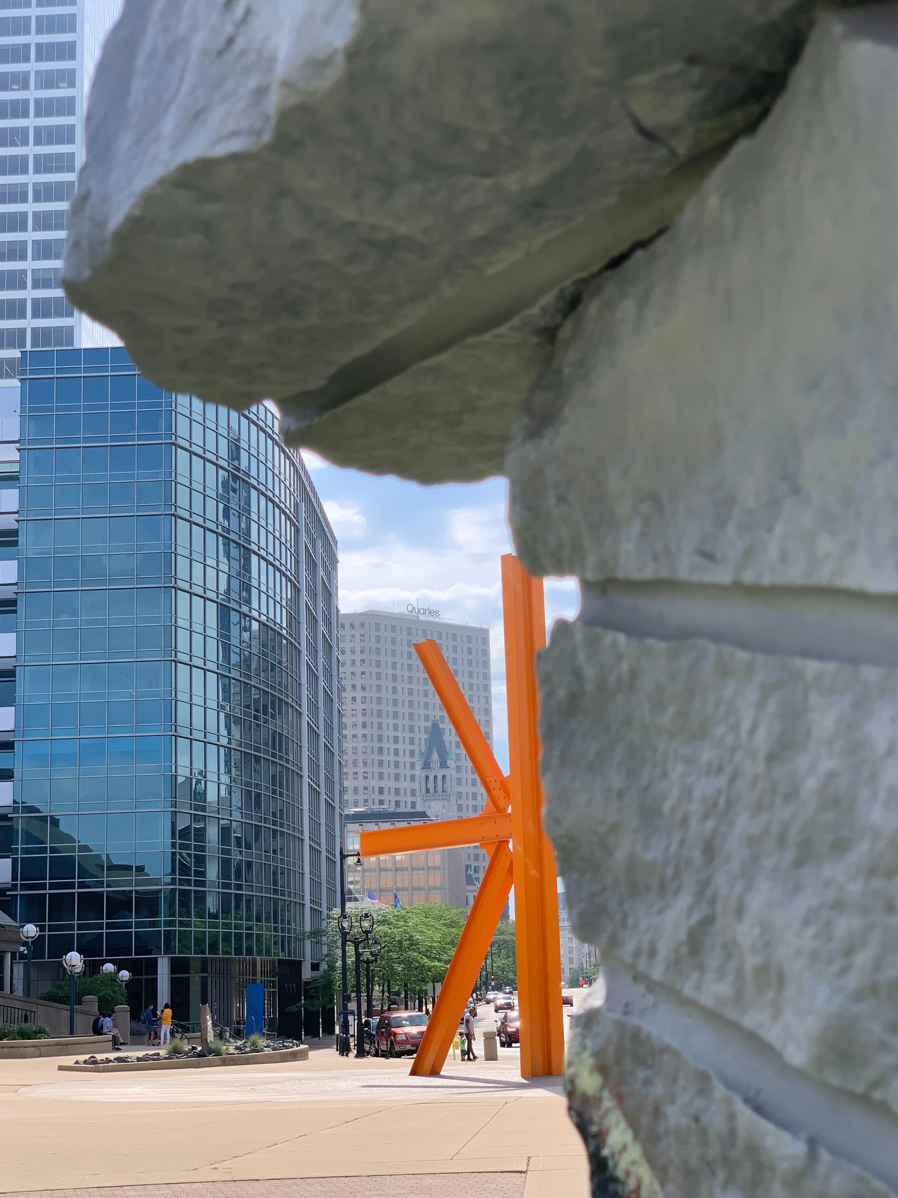 A view of a city from behind a stone wall