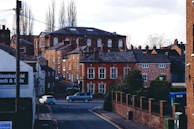 A view of a city street with cars parked on the side of the road