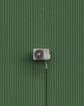 A green wall with a white and black object on it