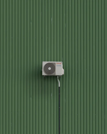 A green wall with a white and black object on it