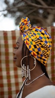 A woman wearing a yellow and blue head wrap