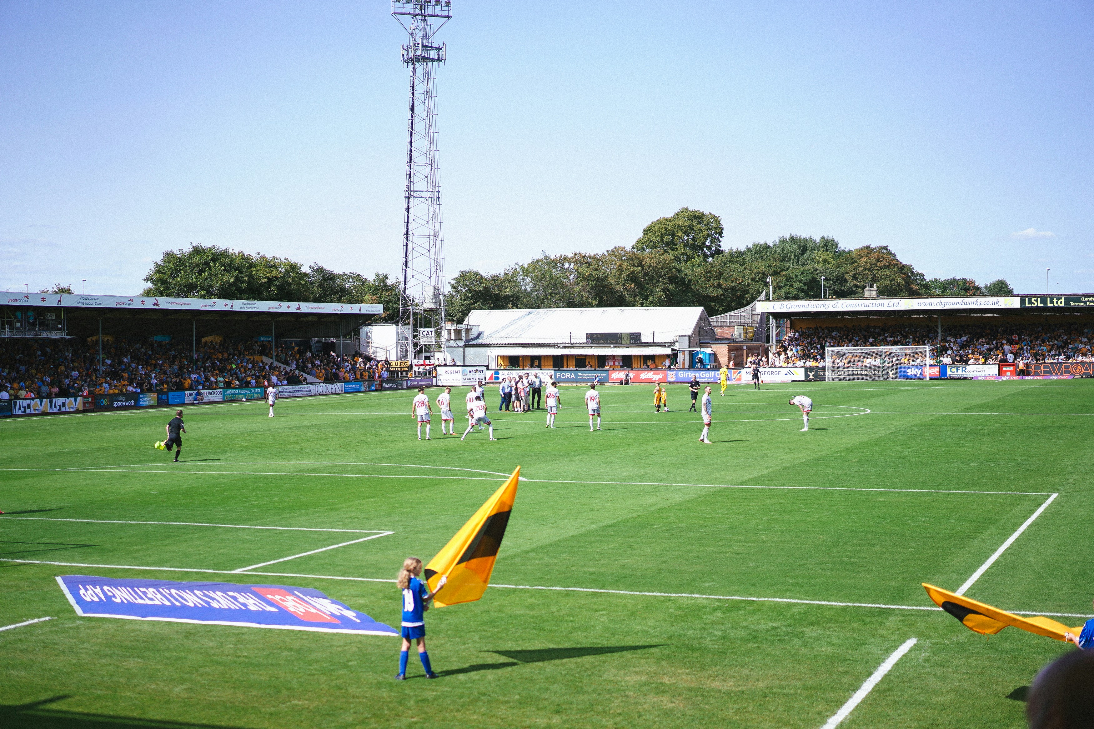 A group of people standing on top of a soccer field