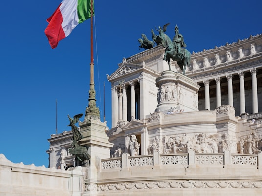 A flag flying in front of a building