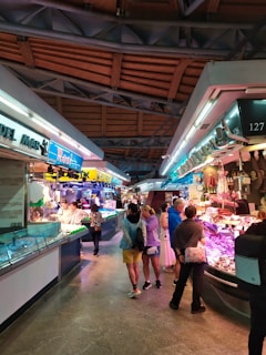 A group of people standing around a fish market