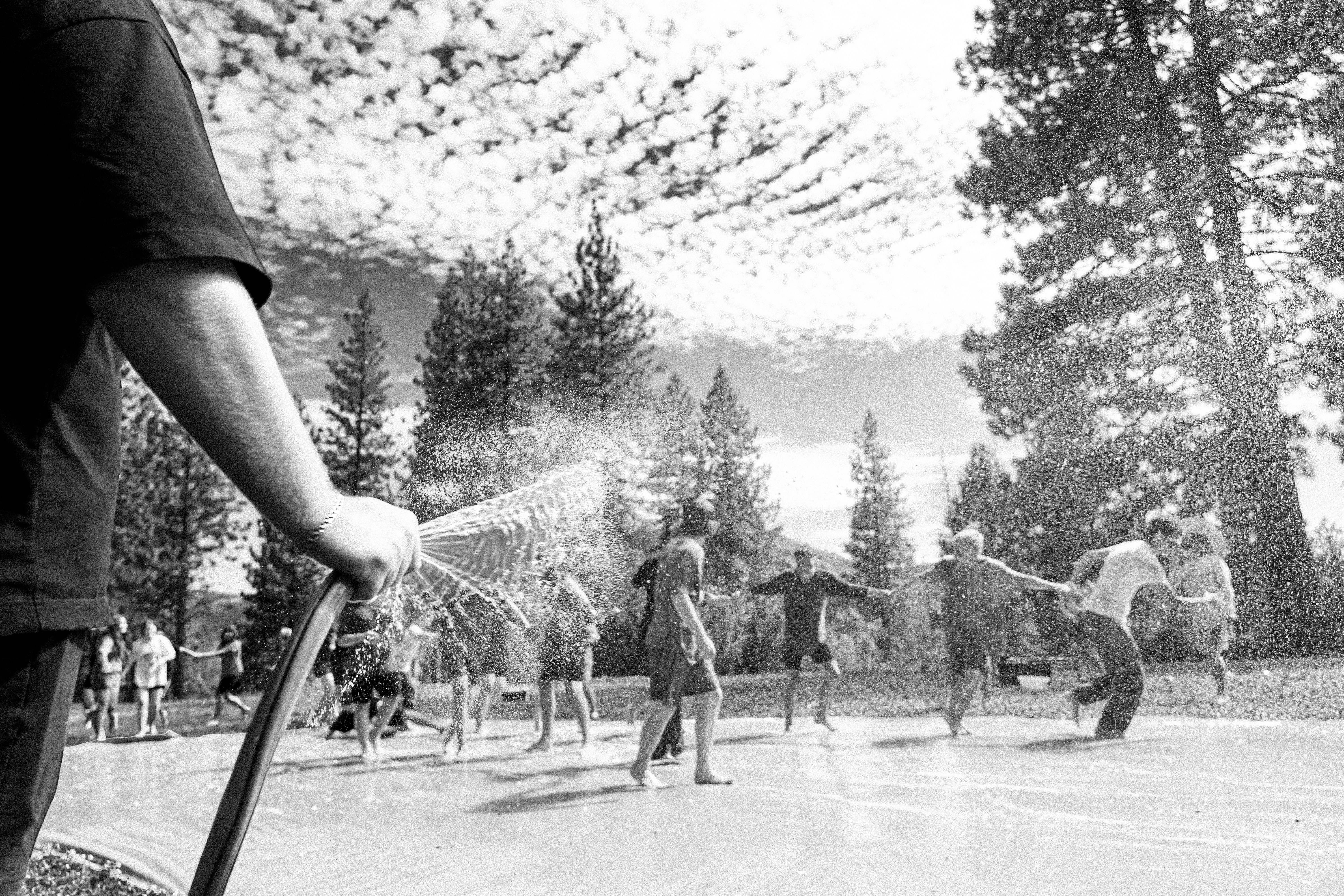 A black and white photo of a group of people skating