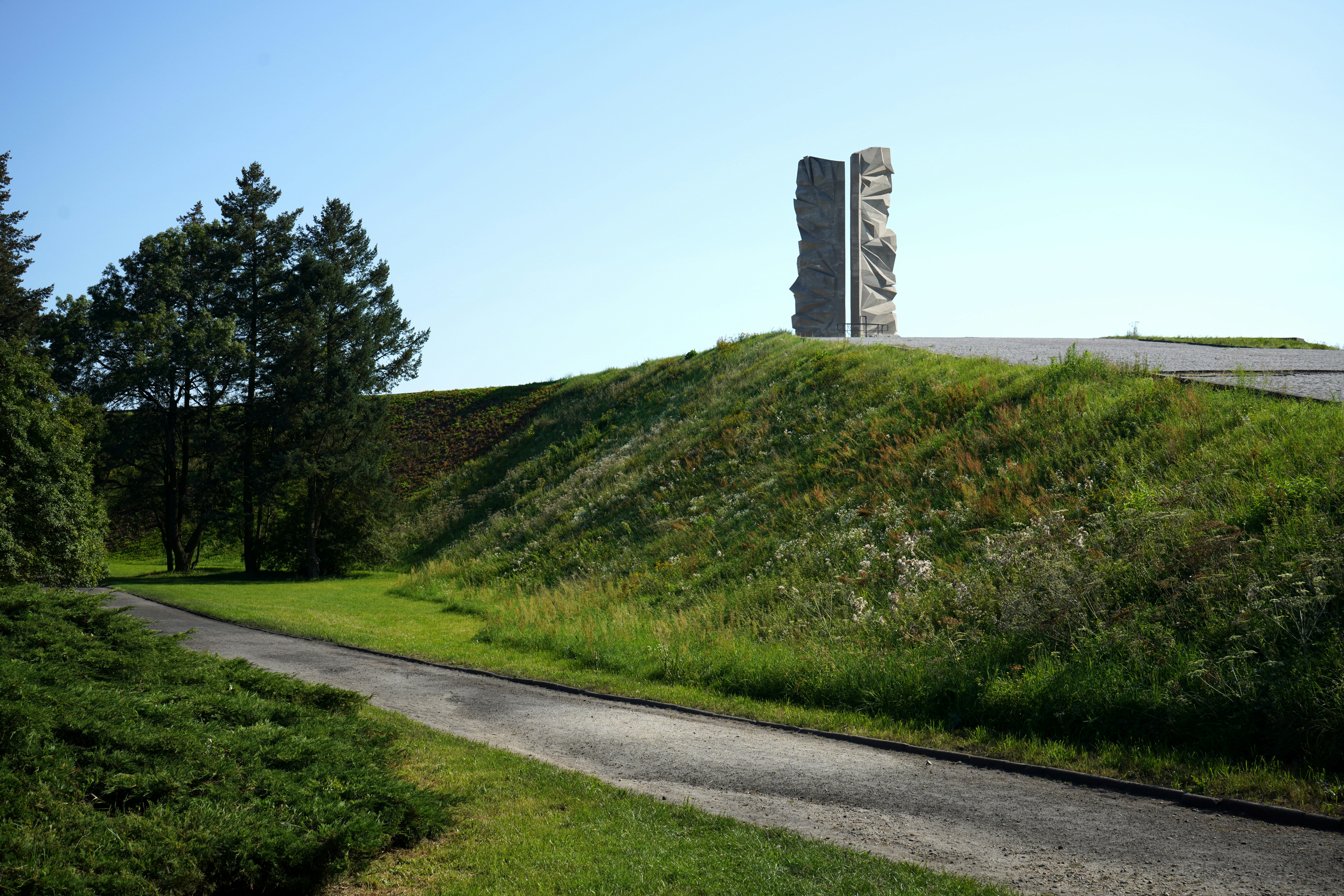 A grassy hill with a tower in the distance
