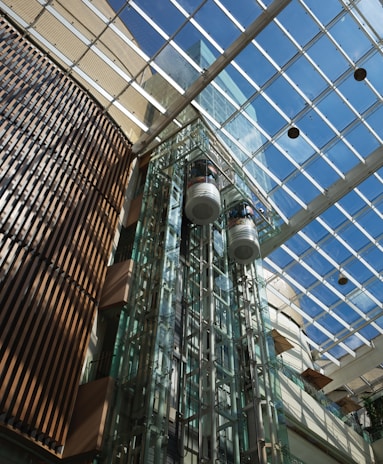A tall glass building with a skylight above it