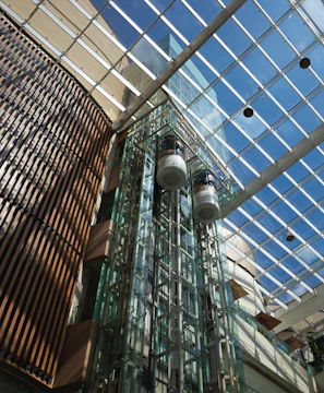 A tall glass building with a skylight above it