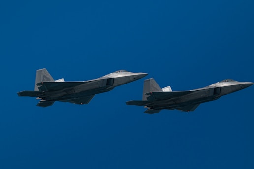 Two fighter jets are flying in the sky