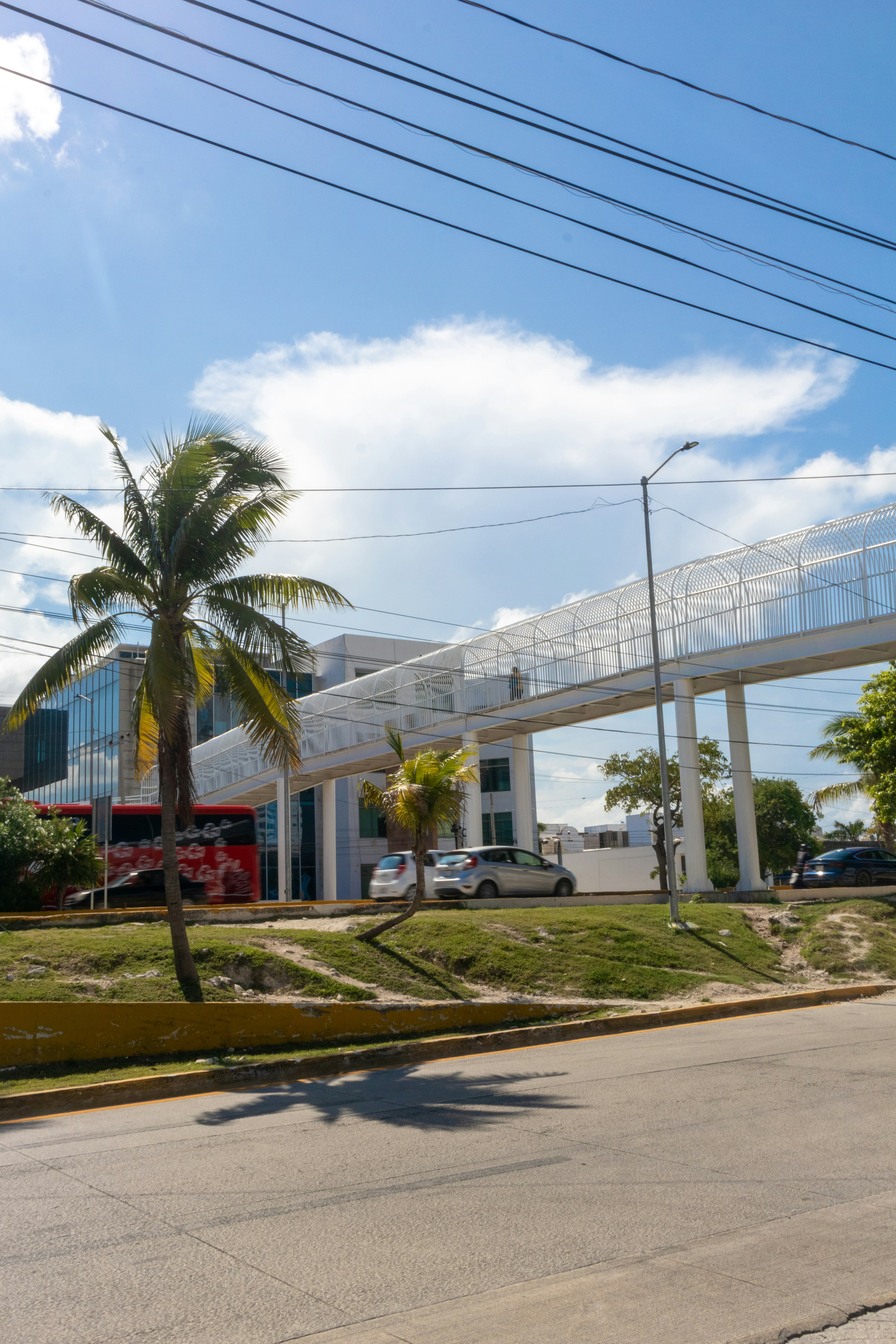 A view of a street with a bridge in the background