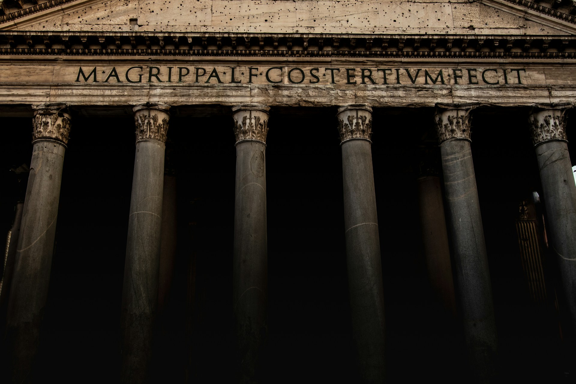 A tall building with columns and a clock