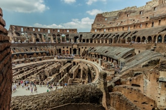 The interior of an old building with people walking around
