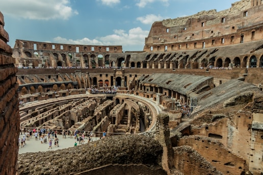 The interior of an old building with people walking around