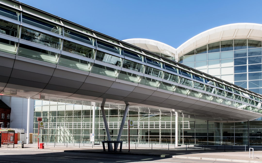 A large building with many windows and a walkway,