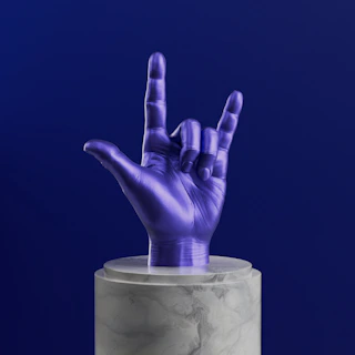 A purple hand sticking out of a marble container