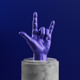 A purple hand sticking out of a marble container