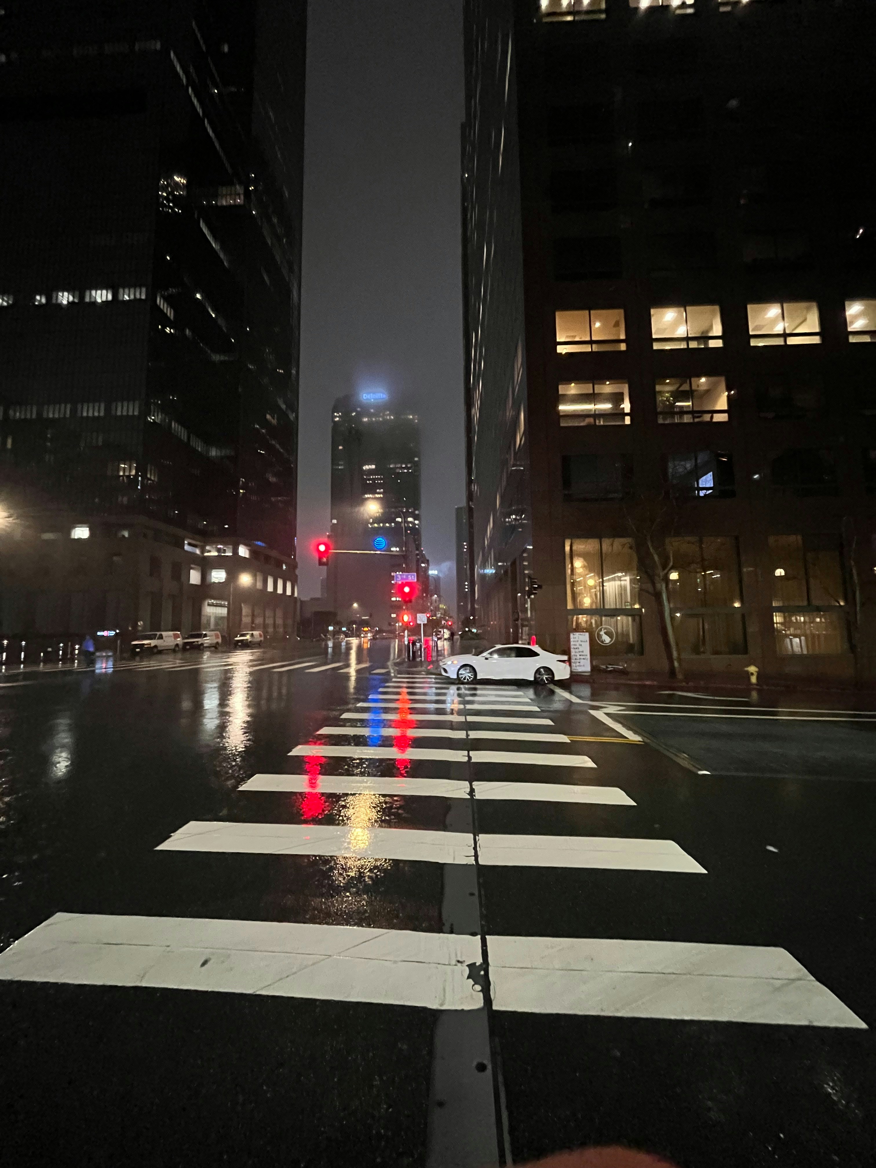 A city street at night with a red traffic light photo – Free Car Image ...