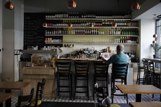 A man sitting at a bar in a restaurant