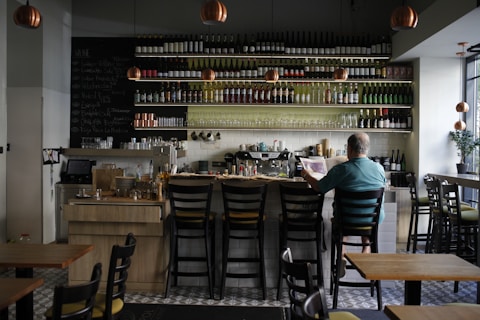 A man sitting at a bar in a restaurant