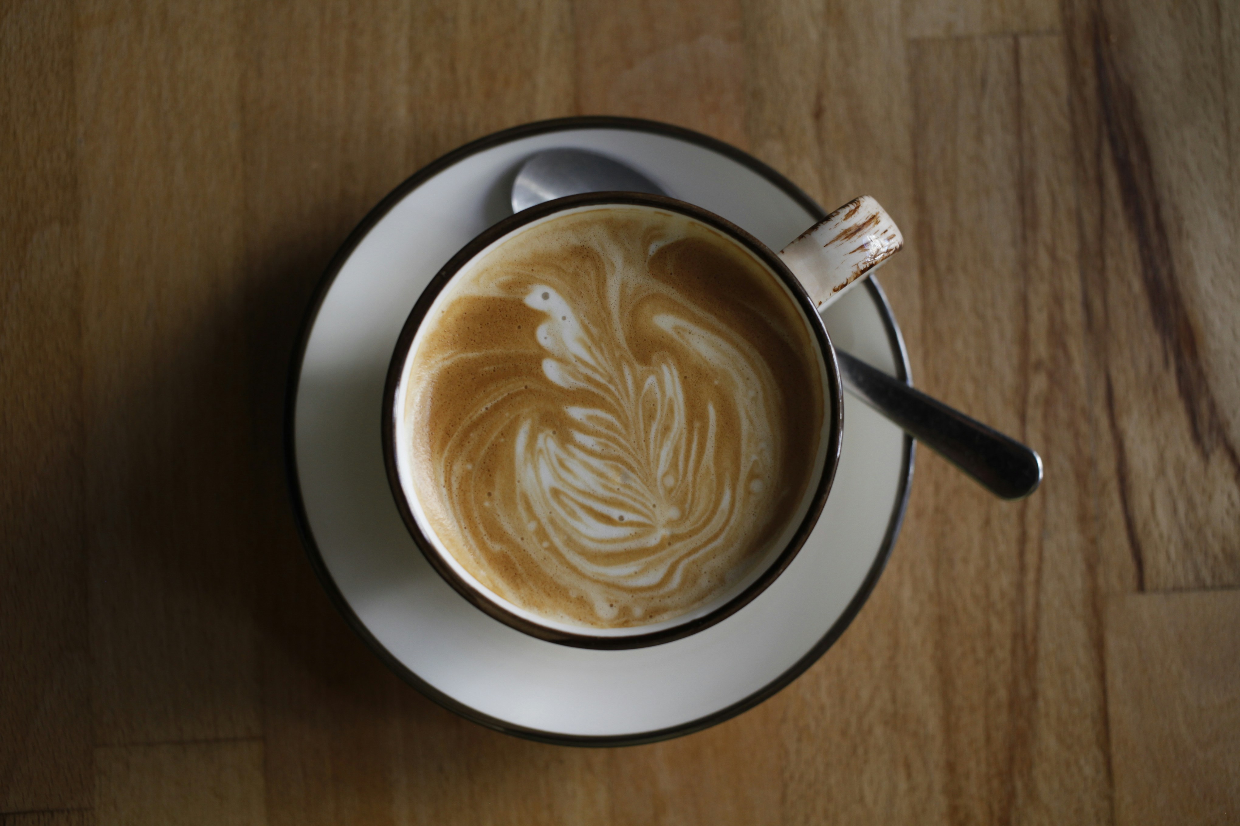 A cup of coffee sitting on top of a wooden table