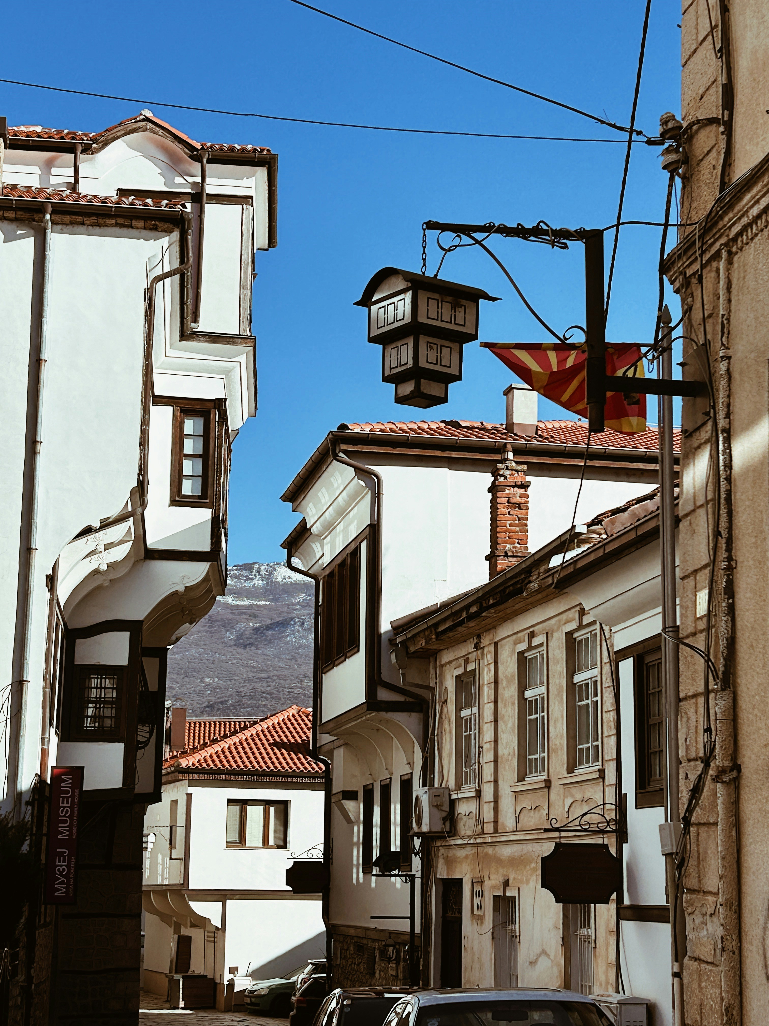 A car driving down a street next to tall buildings