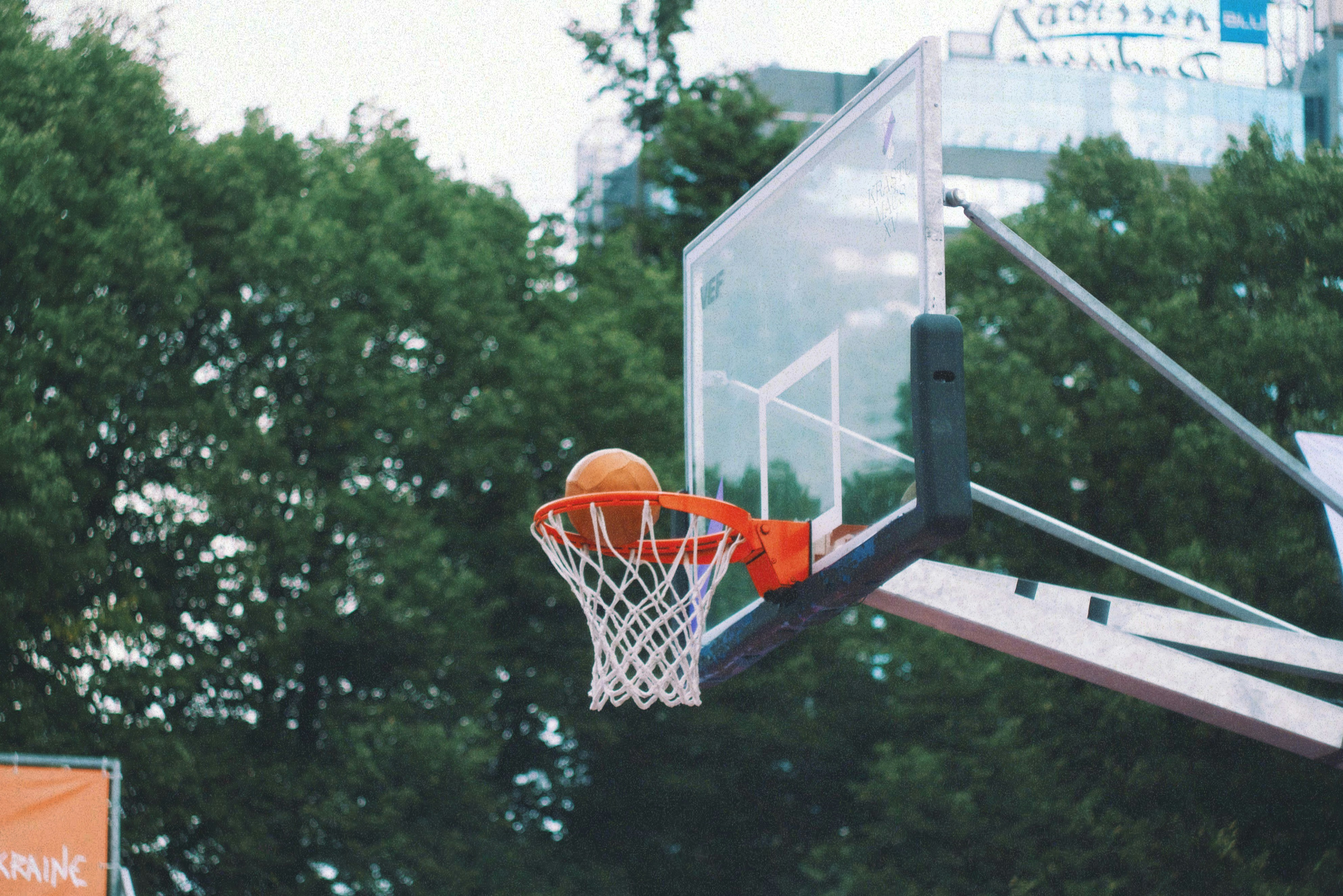 A basketball going through the hoop at a basketball game