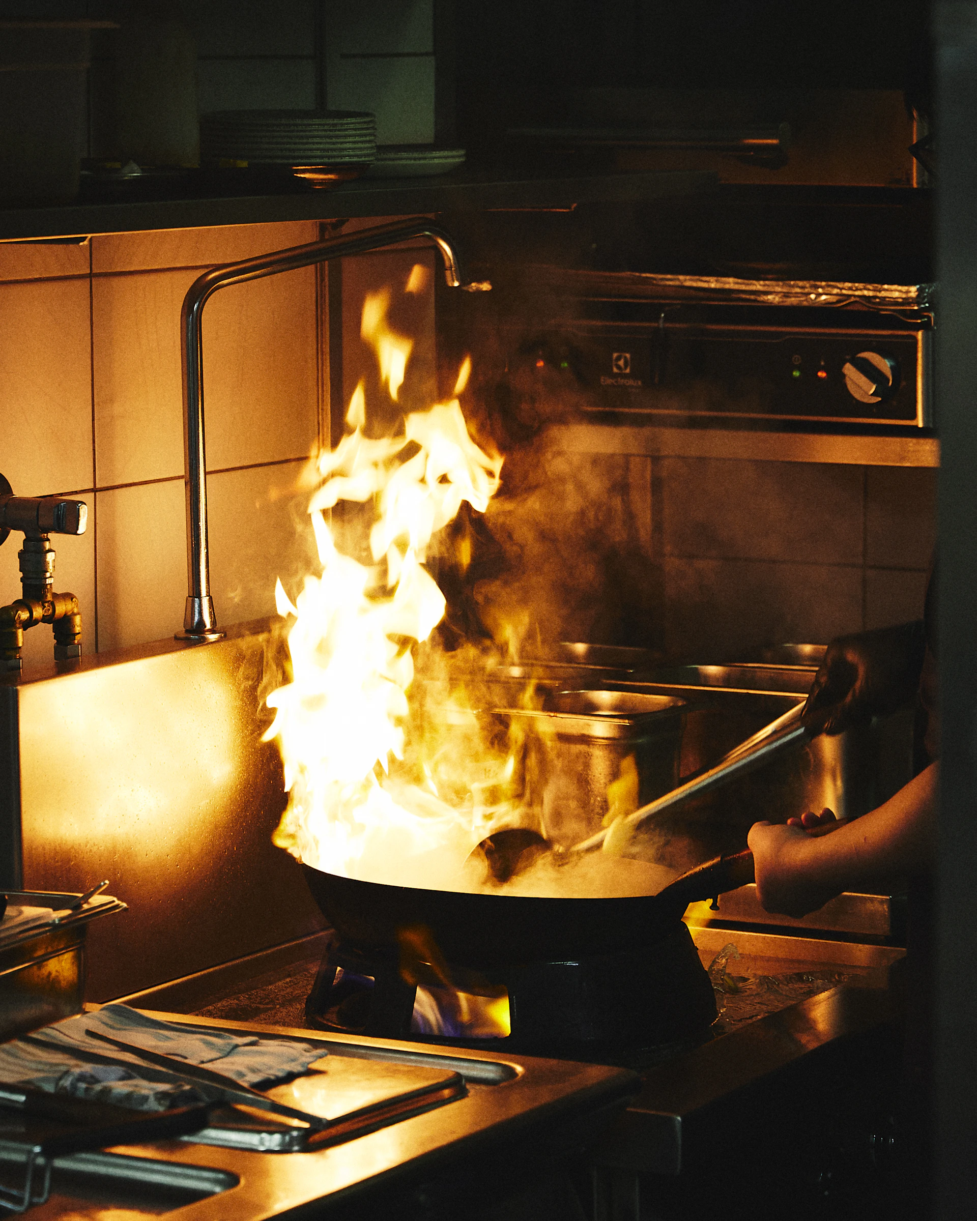 A large pot on a stove with flames in it