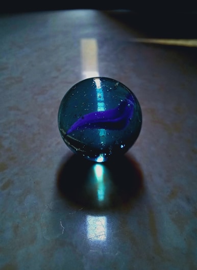A glass ball sitting on top of a table