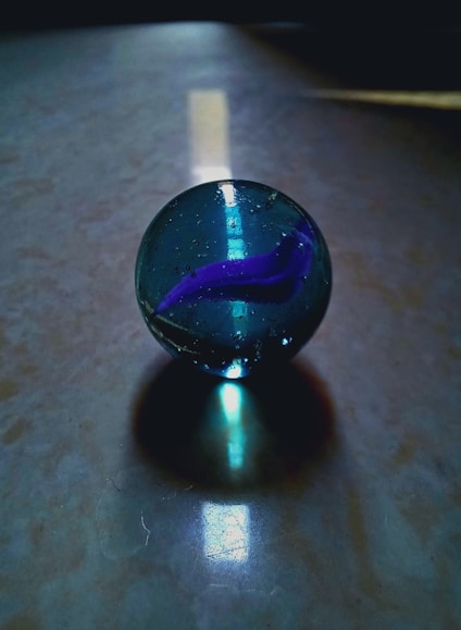 A glass ball sitting on top of a table