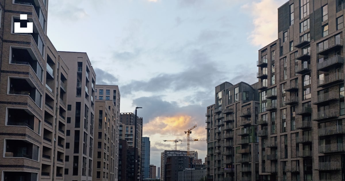 A street lined with tall buildings next to a street photo – Free Random ...
