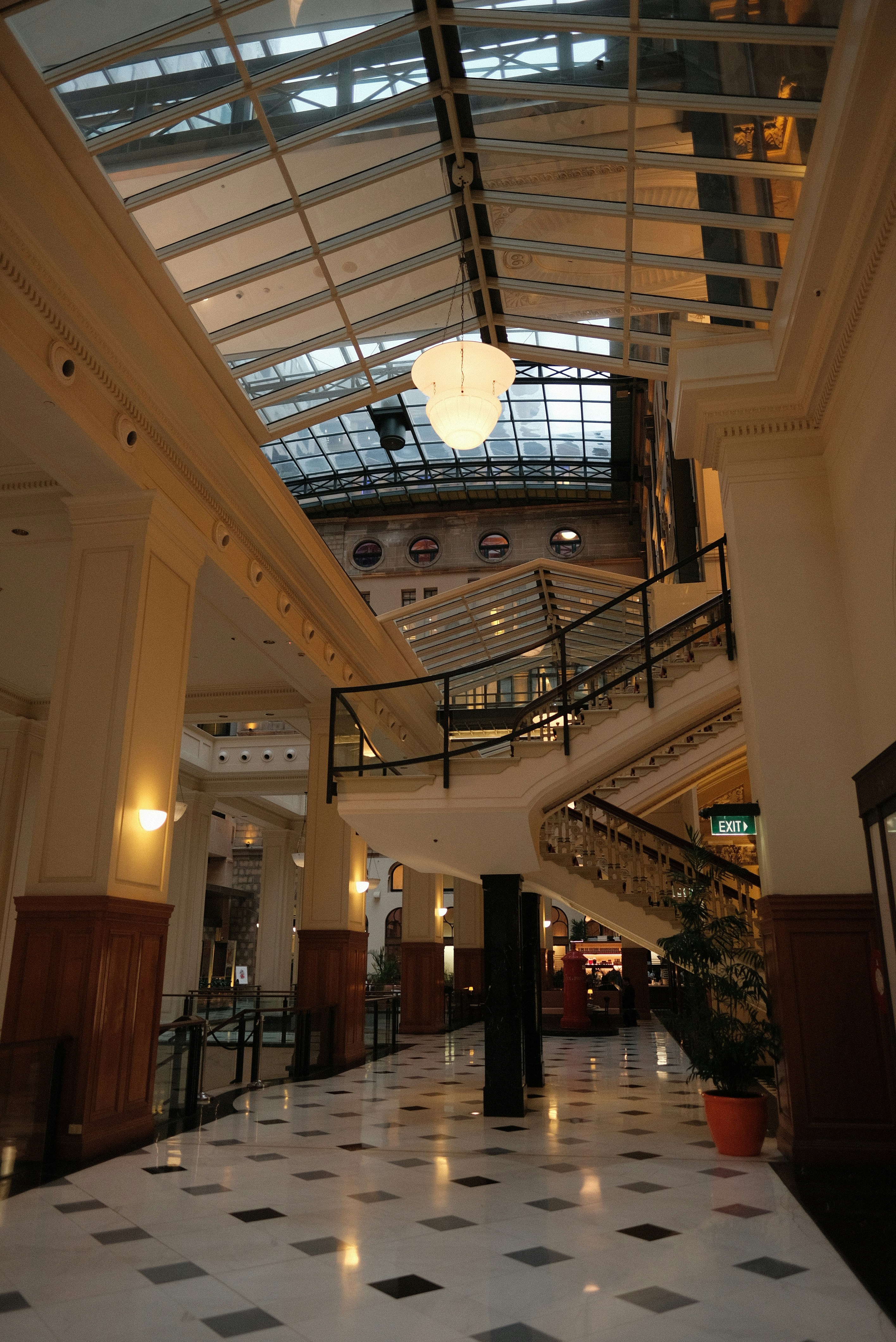 A large lobby with a skylight and tiled floor