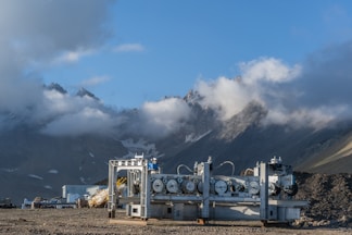 A group of pipes sitting on top of a dry grass field