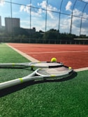 A tennis racket and ball on a tennis court